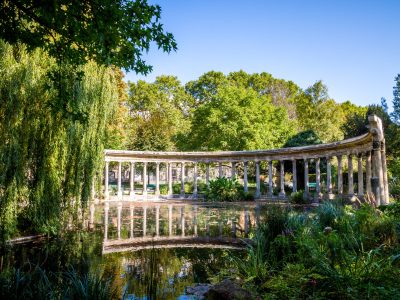 Corinthian colonnade and pond in Parc Monceau gardens, Paris, France